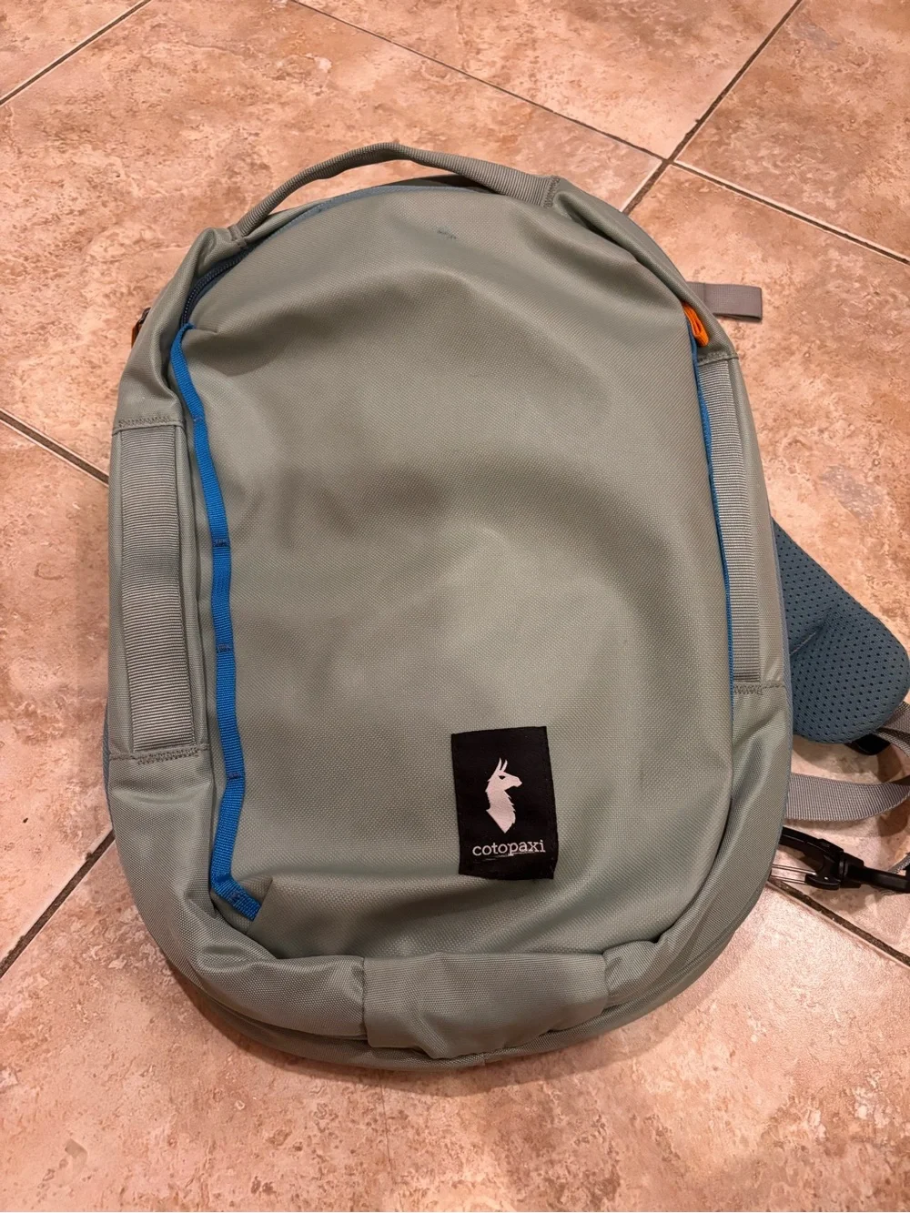 cotopaxi sage green backpack with blue trim
